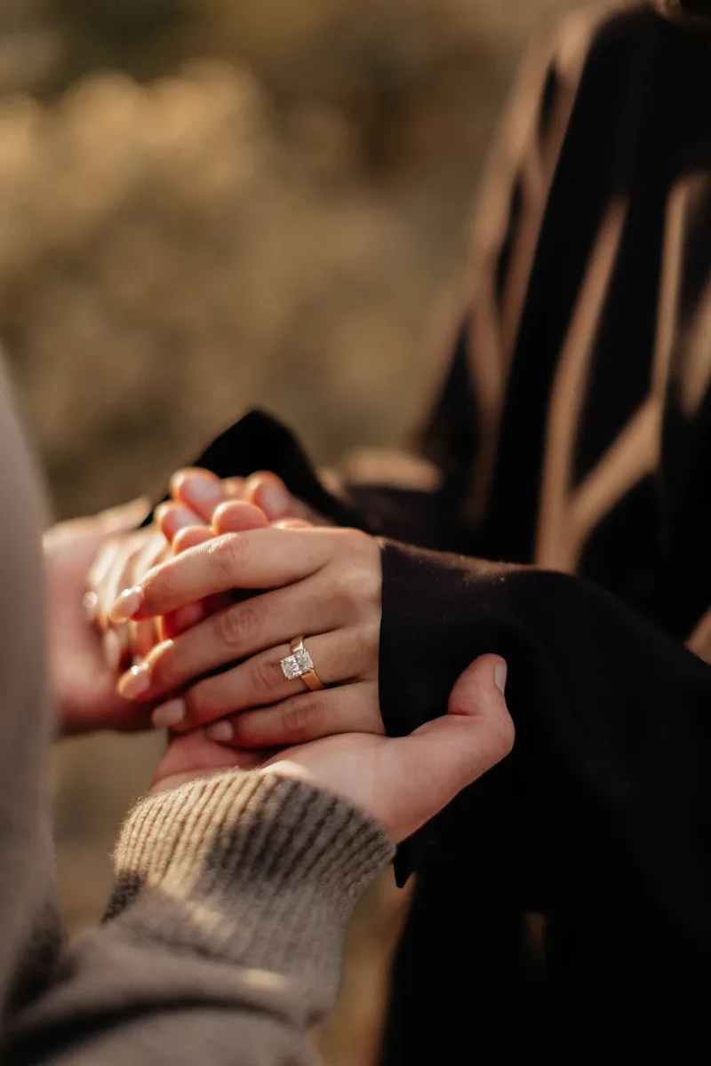 hands with engagement ring in the fall in fort collins colorado